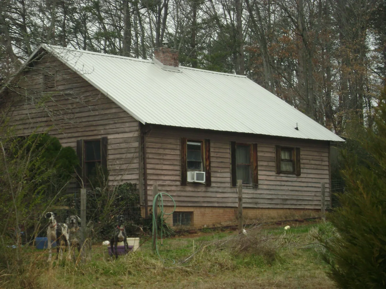 White metal roof on an old wood sided farmhouse, from a Metal Roof Installation job in Continental